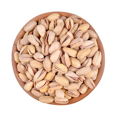 Pistachios in a wooden bowl on a white background
