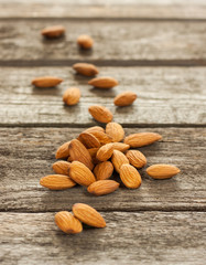 Almonds nuts on vintage planked wood table