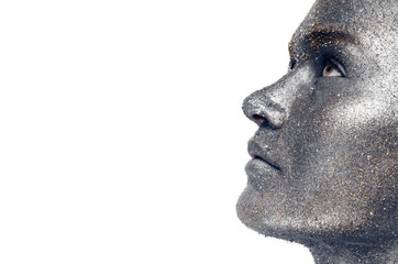 Beautiful face of a woman covered in glitter