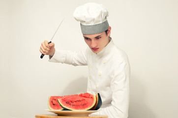 Chef cutting a green riped melon in perfect slices