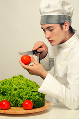 Chef preparing a green salad for a perfect healthy life