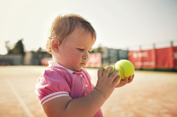 Fototapeta premium little funny girl with tennis ball