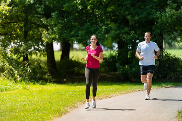 Boyfriend and girlfriend running a race outdoors