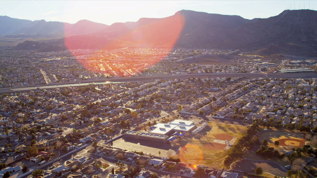 Aerial desert view sun, lens flare metropolitan city, USA