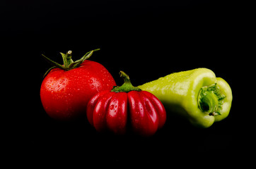 vegetables in front of black background.