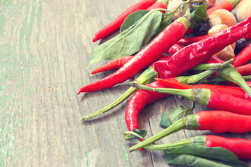heap of red peppers on a wooden background
