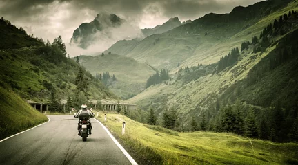 Fotobehang Motorcyclist on mountainous highway © Anna Om