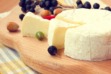 yummy sliced camembert cheese on a wooden board