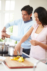 Indian Couple Cooking Meal At Home