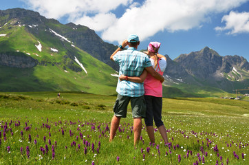 Travelers in an Alpine meadow. Melchsee-Frutt, Switzerland