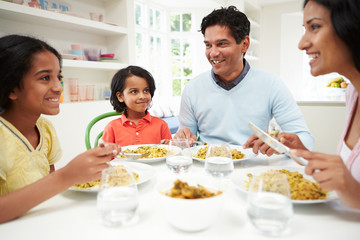 Indian Family Eating Meal At Home