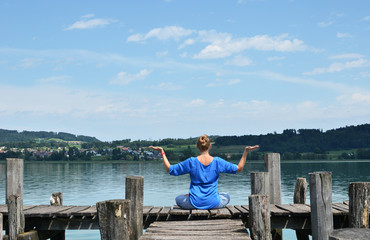 Fototapeta premium Girl on the wooden jetty. Switzerland