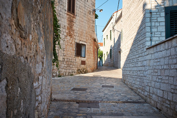 Narrow Alley With Old Buildings In Typical Croatia Medieval Town