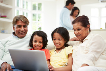 Indian Family With Laptop At Home
