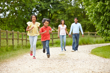 Indian Family Walking In Countryside