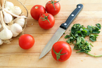 cutting board with tomatoes and knife