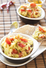 Fresh guacamole with tomatoes