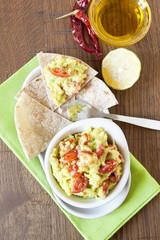 Fresh guacamole with tomatoes