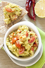 Fresh guacamole with tomatoes