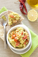 Fresh guacamole with tomatoes
