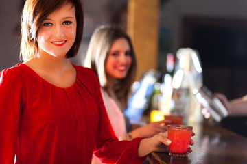 Friends having a round of drinks in a pub