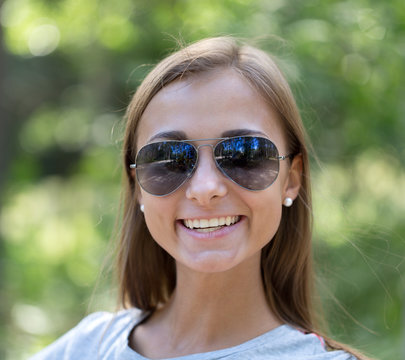 portrait of a girl in sunglasses in the forest