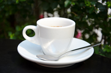 White espresso cup standing on the street cafe table
