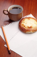 Sheet of paper, bun and coffee