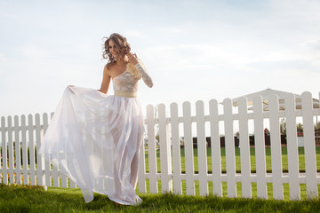 walking model in bride dress outdoors. 