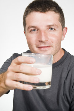 Healthy Young  Man drinking a Glass of Milk
