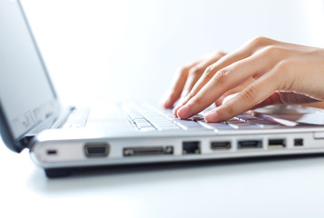 Hands typing on the laptop
