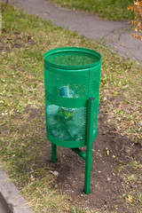 green rubbish bin in nature