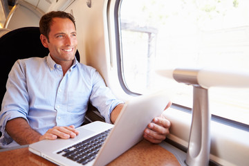 Man Using Laptop On Train