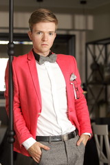 Young handsome stylish man posing indoor