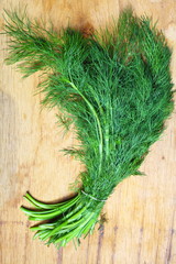 bunch fresh dill herb on wooden table