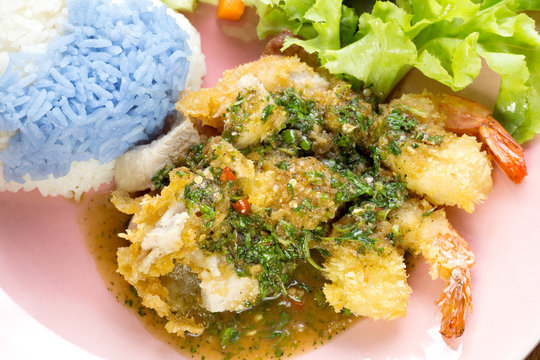 Rice with basil sauce chicken pork shrimps Thai food