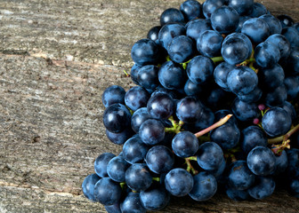 blue grapes on wooden surface
