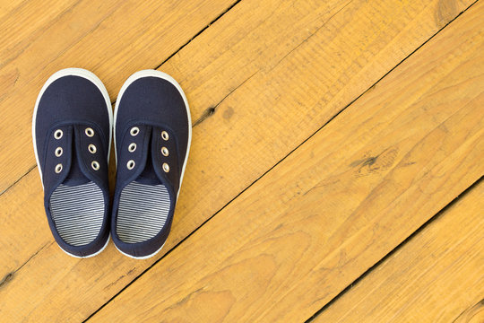 Blue shoes on wooden floor