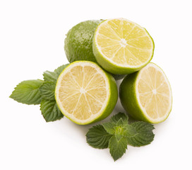 Fresh limes, mint leaves isolated on white