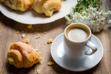 Fototapeta na wymiar Closeup of espresso and croissant for breakfast