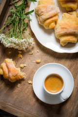 Flowers, croissants, espresso for breakfast
