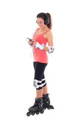 beautiful woman in roller skates listening music on white backgr