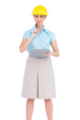 Thoughtful attractive architect holding clipboard