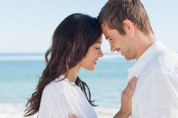 Romantic couple relaxing and embracing on the beach