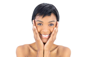 Joyful black haired woman posing holding her head