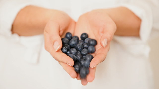 Handful of blueberries getting poured down