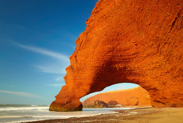 Red archs on atlantic ocean coast. Marocco