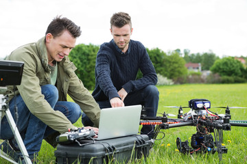 Technicians Using Laptop By UAV Drone