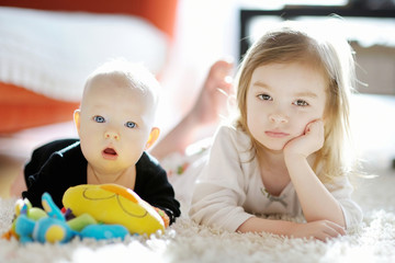 Obraz premium Two sibling sisters at home