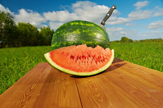 Watermelon Slices On A Wooden Table